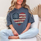 Model is wearing "American Heart Flag Faux Patchwork" graphic on muted medium blue (denim) T-Shirt.