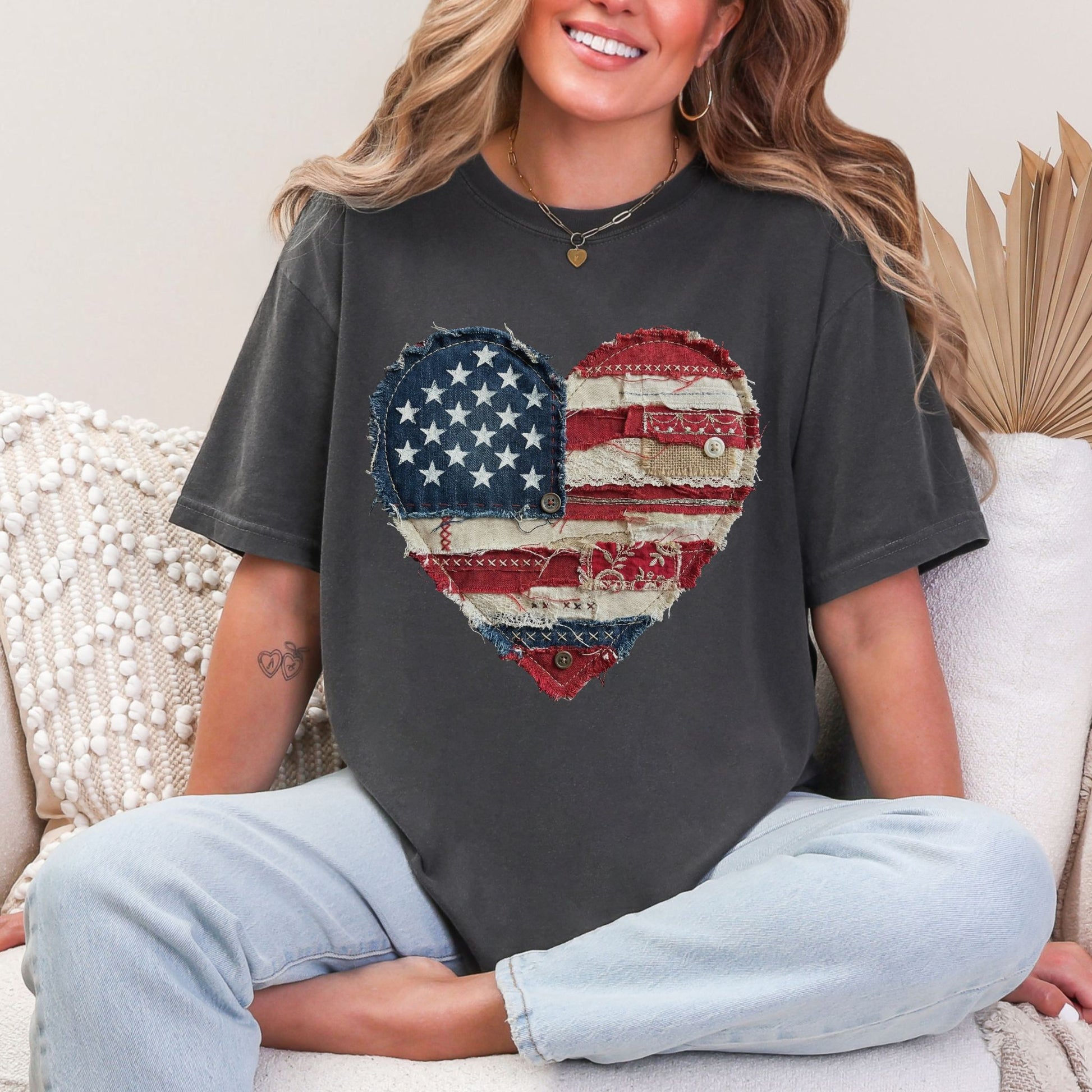 Model is wearing "American Heart Flag Faux Patchwork" graphic on dark charcoal gray (pepper) T-Shirt.