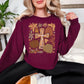 "Autumn Pumpkin and Floral Cross" graphic on deep red (maroon) Gildan 18000 sweatshirt.
