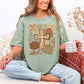 "Autumn pumpkin floral cross" graphic on muted teal-green (bay) Comfort colors 1717 T-shirt.