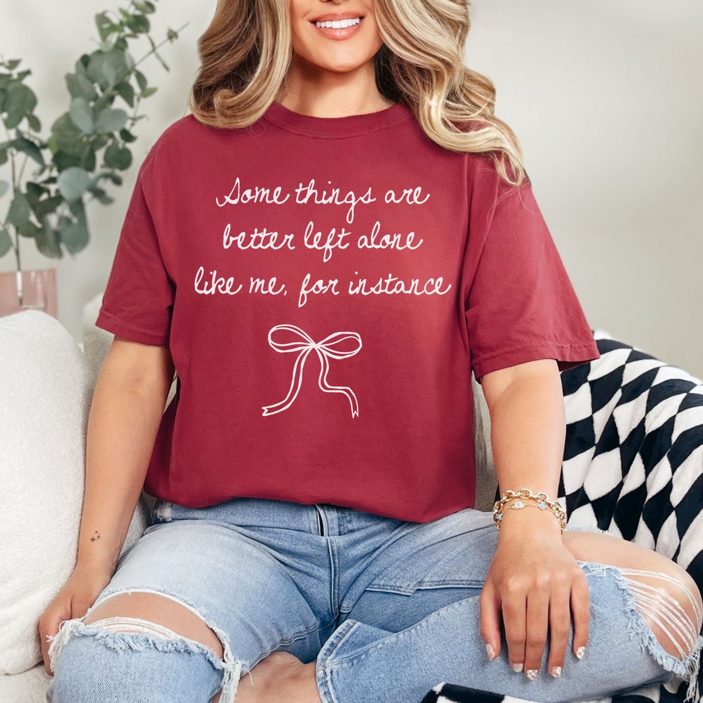 "Better Left Alone" graphic on a muted brick red (chili) t-shirt.