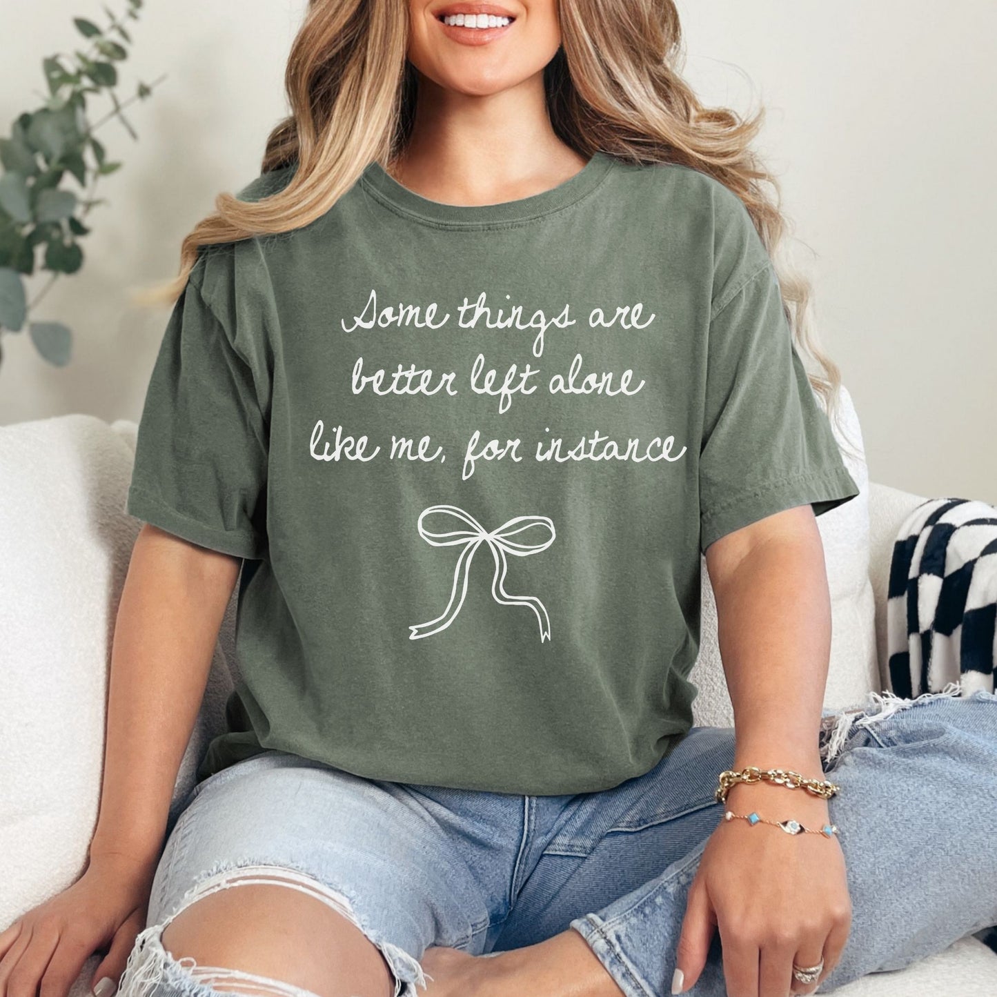 "Better Left Alone" graphic on a muted earthy green (moss) t-shirt.