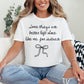 Model wearing a Comfort Colors 1717 t-shirt in bright white (white) color featuring a graphic of a hand written font saying "Some things are better left alone like me, for instance”. Underneath the phrase is a bow.