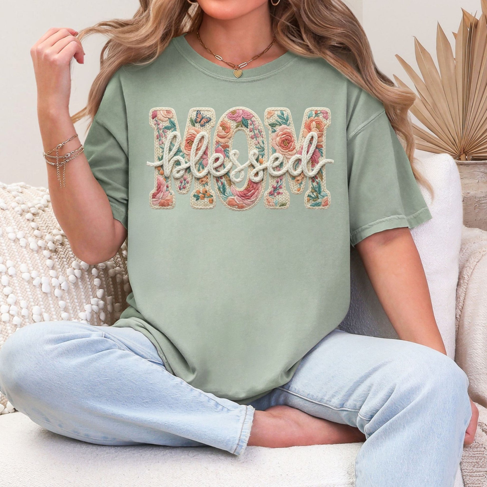 “Blessed Mom" graphic on muted teal-green (bay) t-shirt.