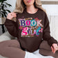 "Book Girl" graphic on deep dark brown (dark chocolate) Sweatshirt.