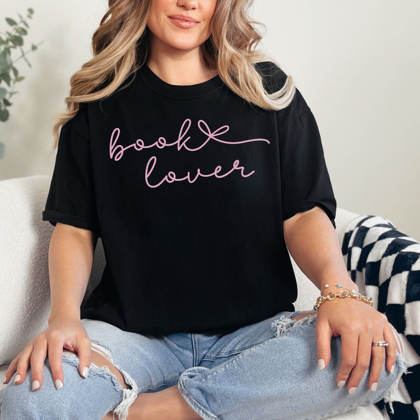 "Book Lover" graphic on a black T-shirt.