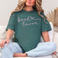 "Book Lover" graphic on muted blue-green (blue spruce) T-shirt.