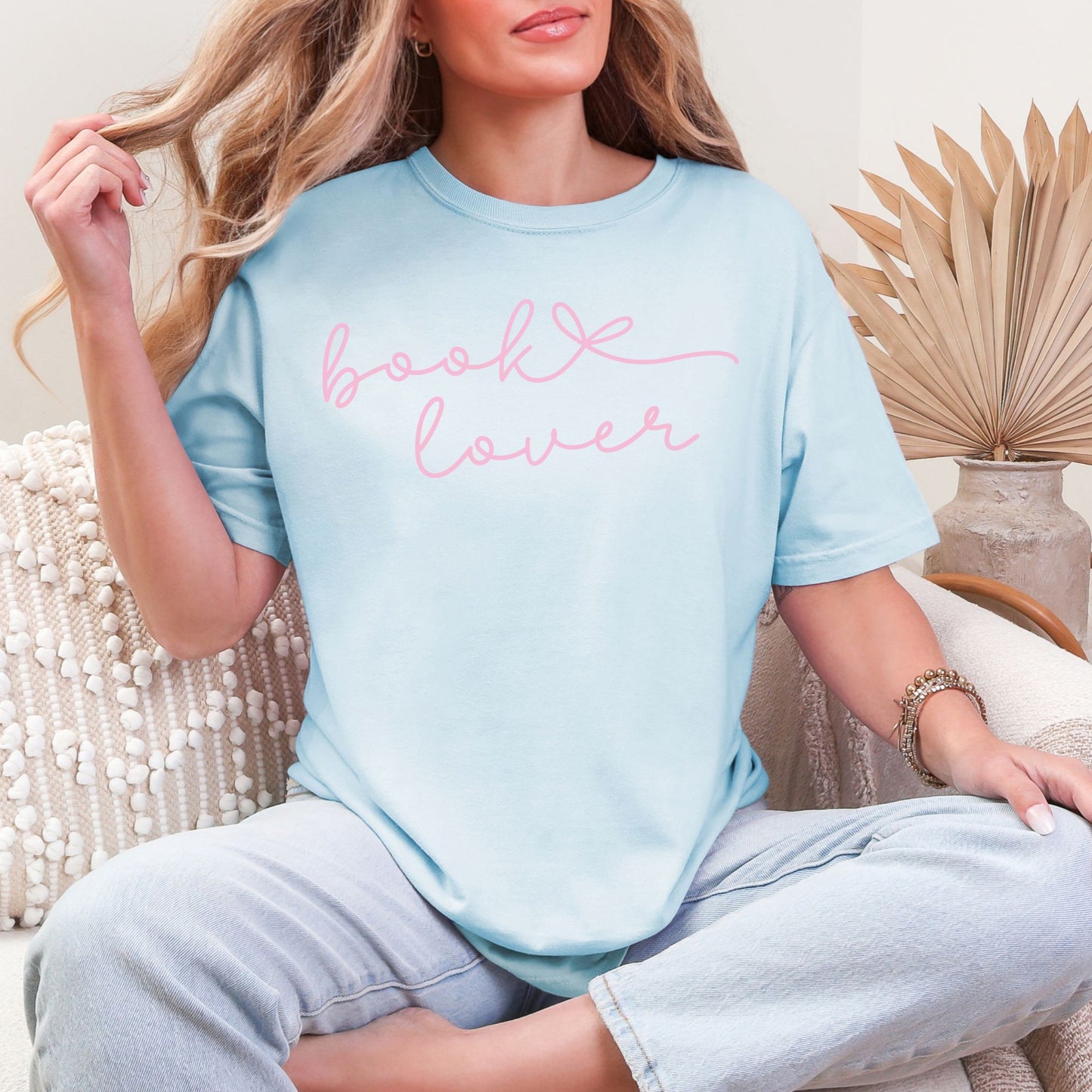 "Book Lover" graphic on a soft medium blue (chambray) T-shirt.