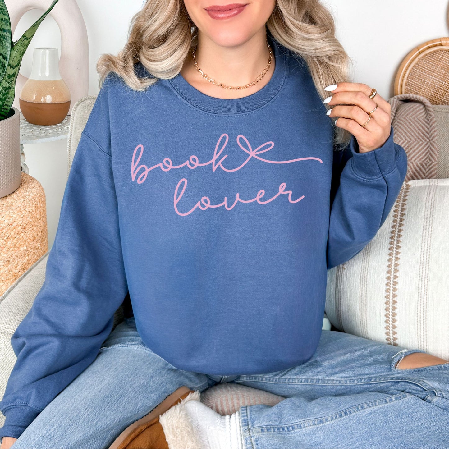 "Book Lover" graphic on rich medium-dark blue (indigo blue) sweatshirt.