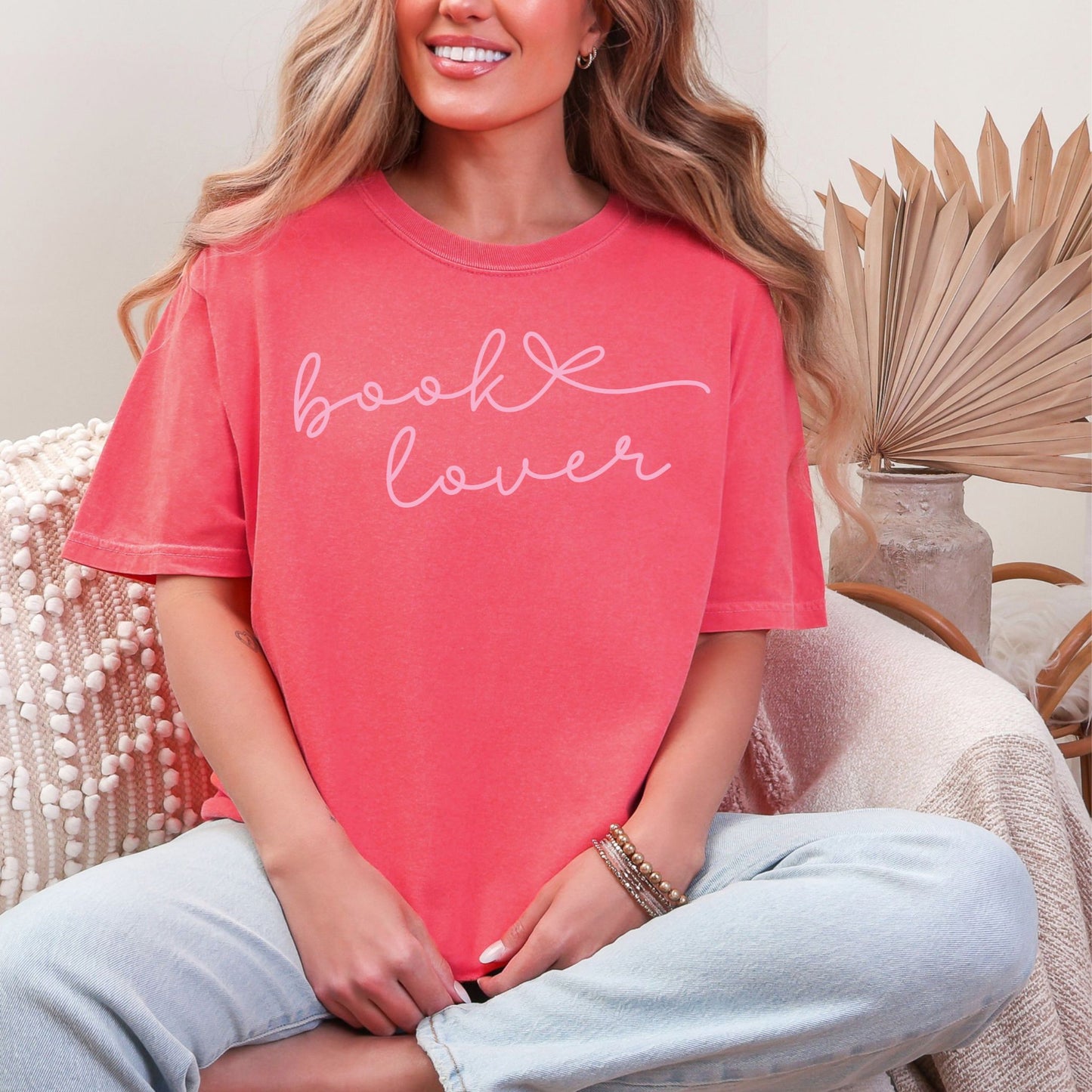 "Book Lover" graphic on a bright coral pink (watermelon) T-shirt.