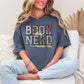 "Book Nerd" graphic on a muted medium blue (denim) t-shirt.