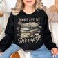 “Books are my therapy" graphic on rich deep black (black) Sweatshirt