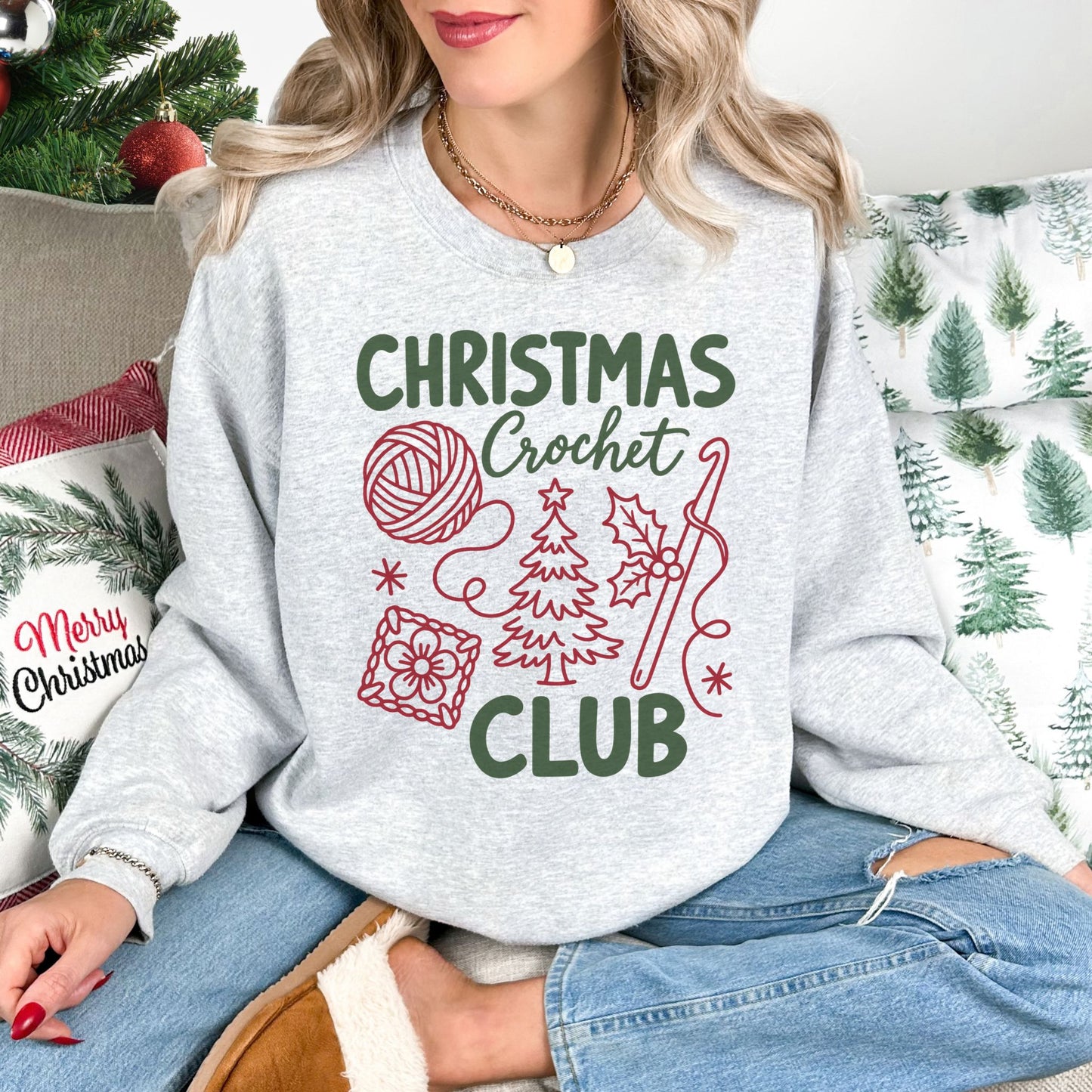 "Christmas Crochet Club" graphic on a Gildan 18000 sweatshirt in the color very light gray (ash).