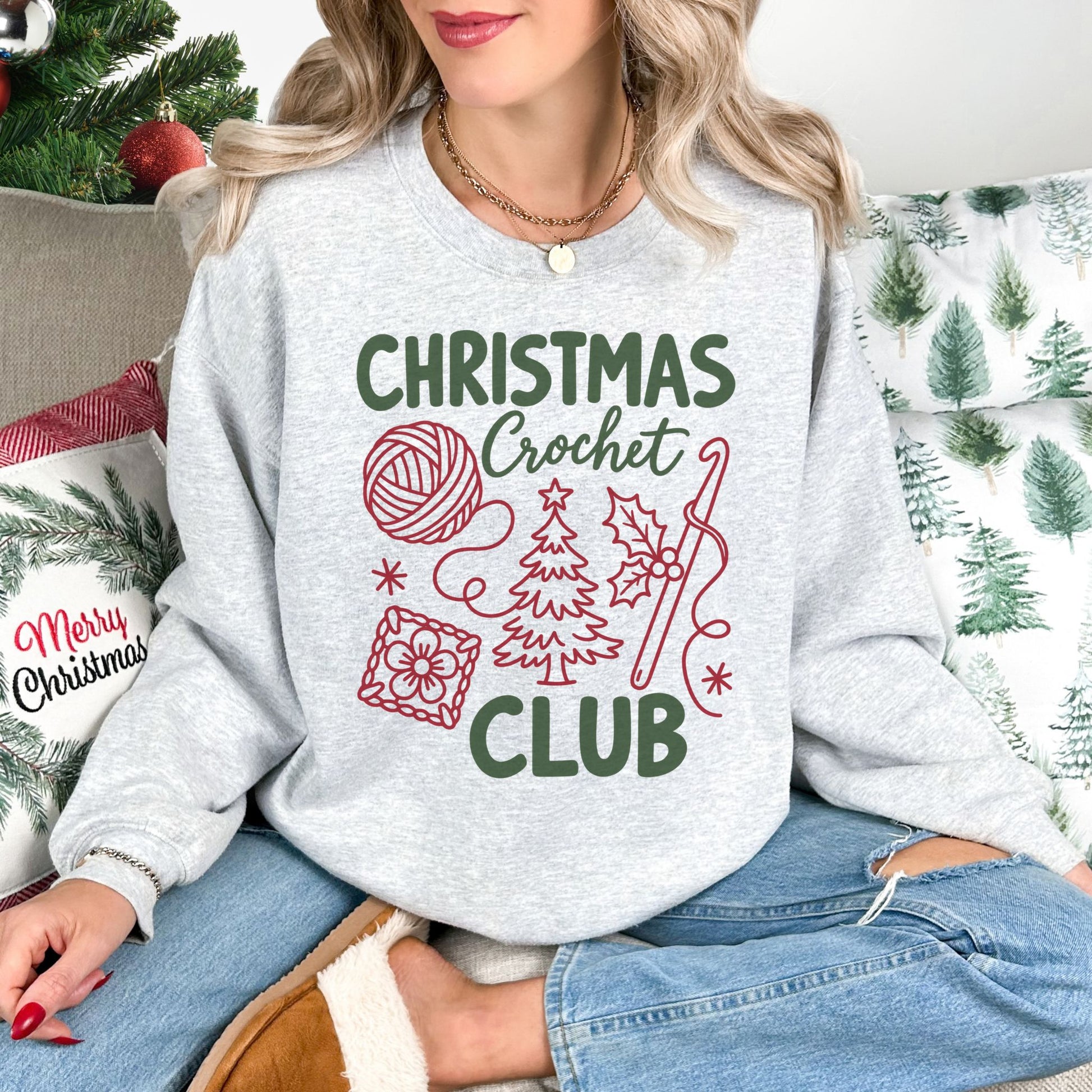 "Christmas Crochet Club" graphic on a Gildan 18000 sweatshirt in the color very light gray (ash).