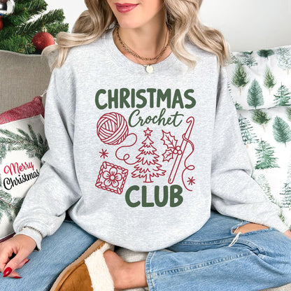 "Christmas Crochet Club" graphic on a Gildan 18000 sweatshirt in the color very light gray (ash).