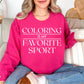 "Coloring Favorite Sport" graphic on bright pink (heliconia) sweatshirt.
