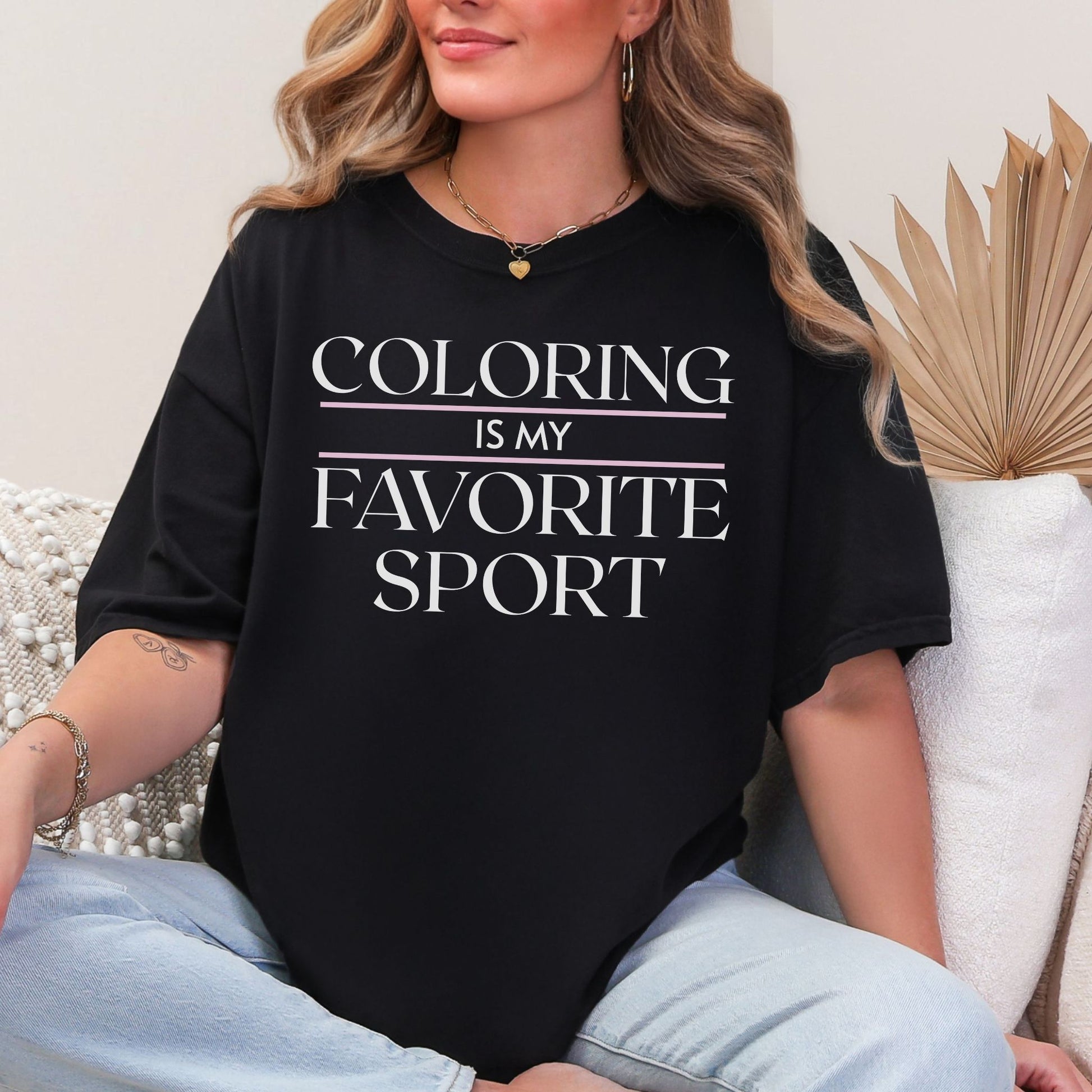 "Coloring is my favorite sport" graphic on a black T shirt. 