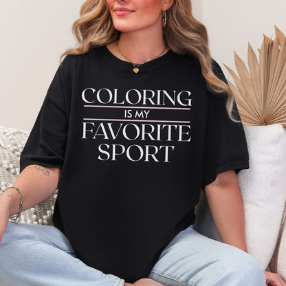 "Coloring is my favorite sport" graphic on a black T shirt. 