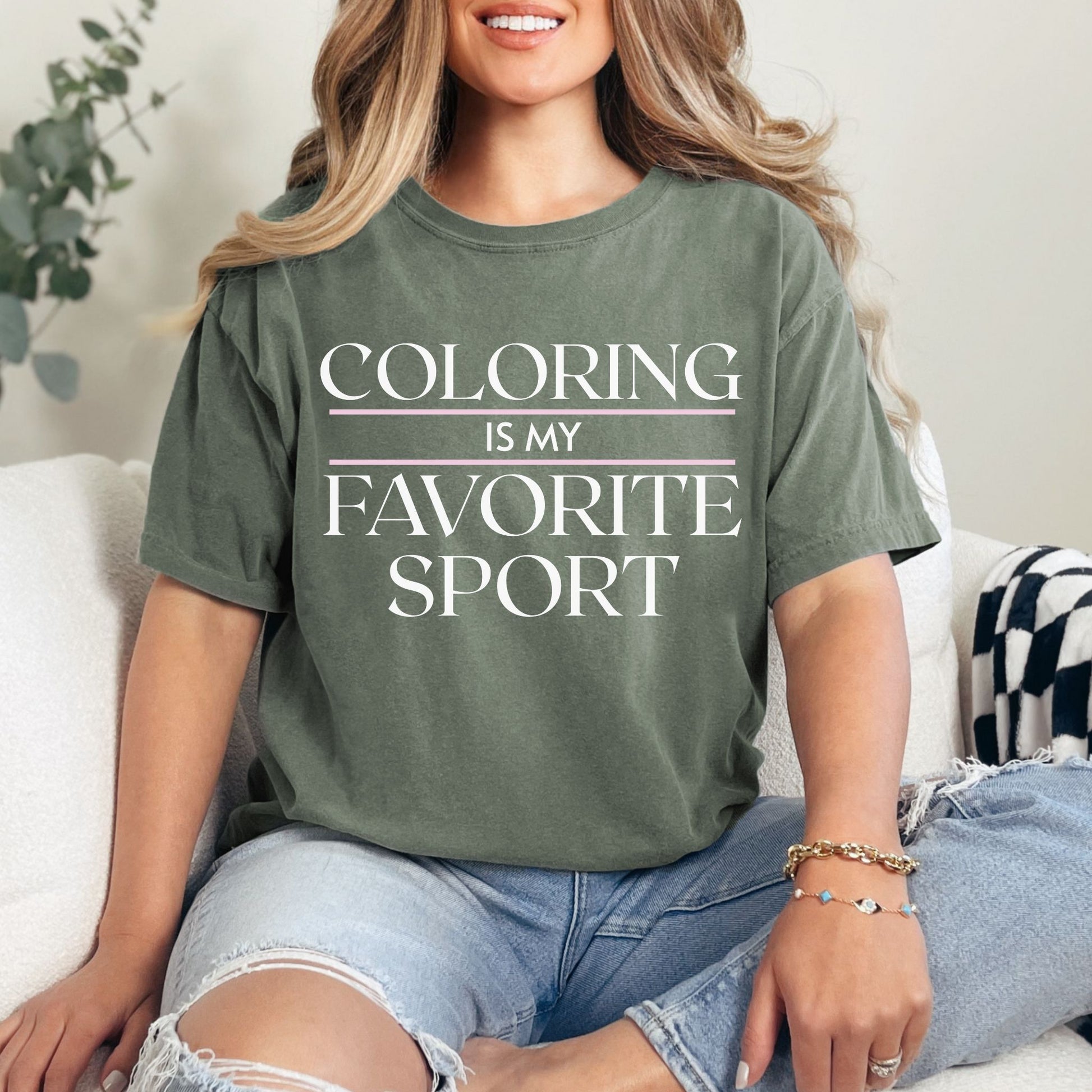 "Coloring is my favorite sport" graphic on muted earthy green (moss) T shirt. 
