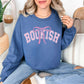 "Coquette Bookish" graphic on rich medium-dark blue (indigo blue) Sweatshirt.