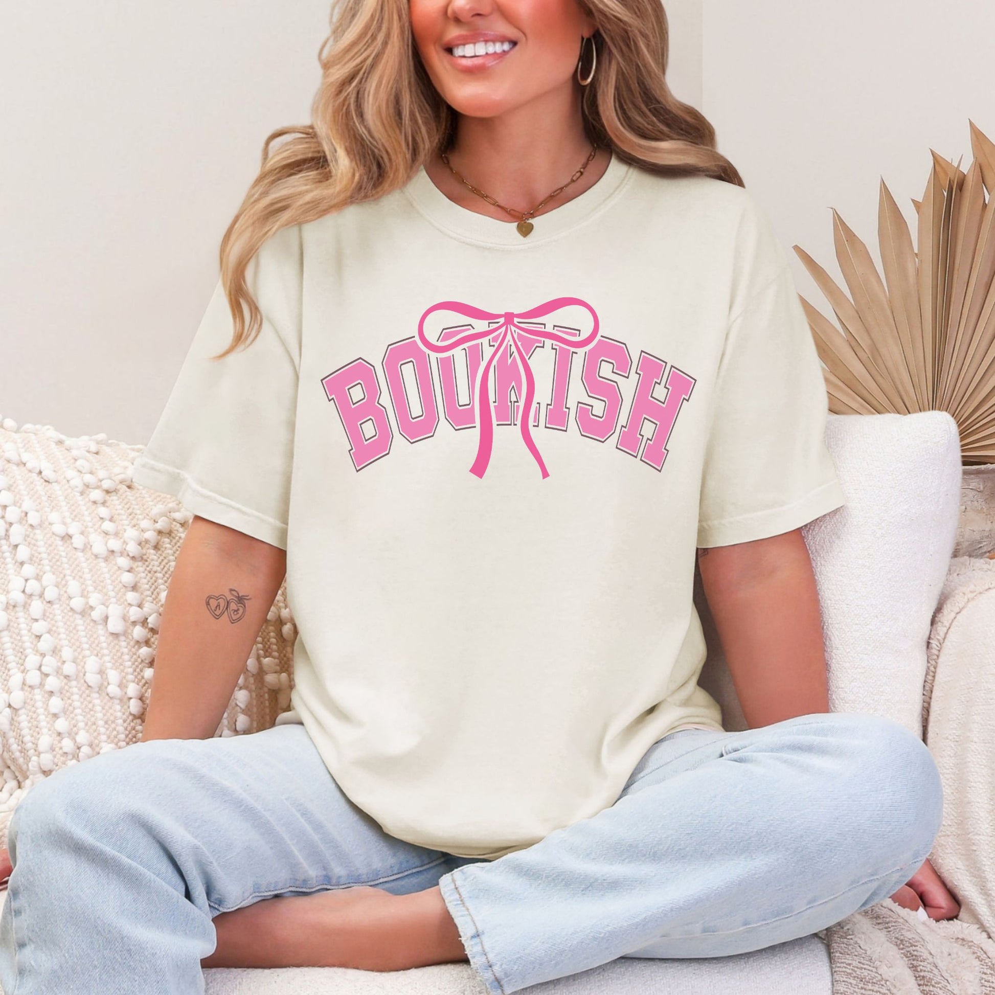 "Coquette Bookish" graphic on soft off-white (ivory) t-shirt.