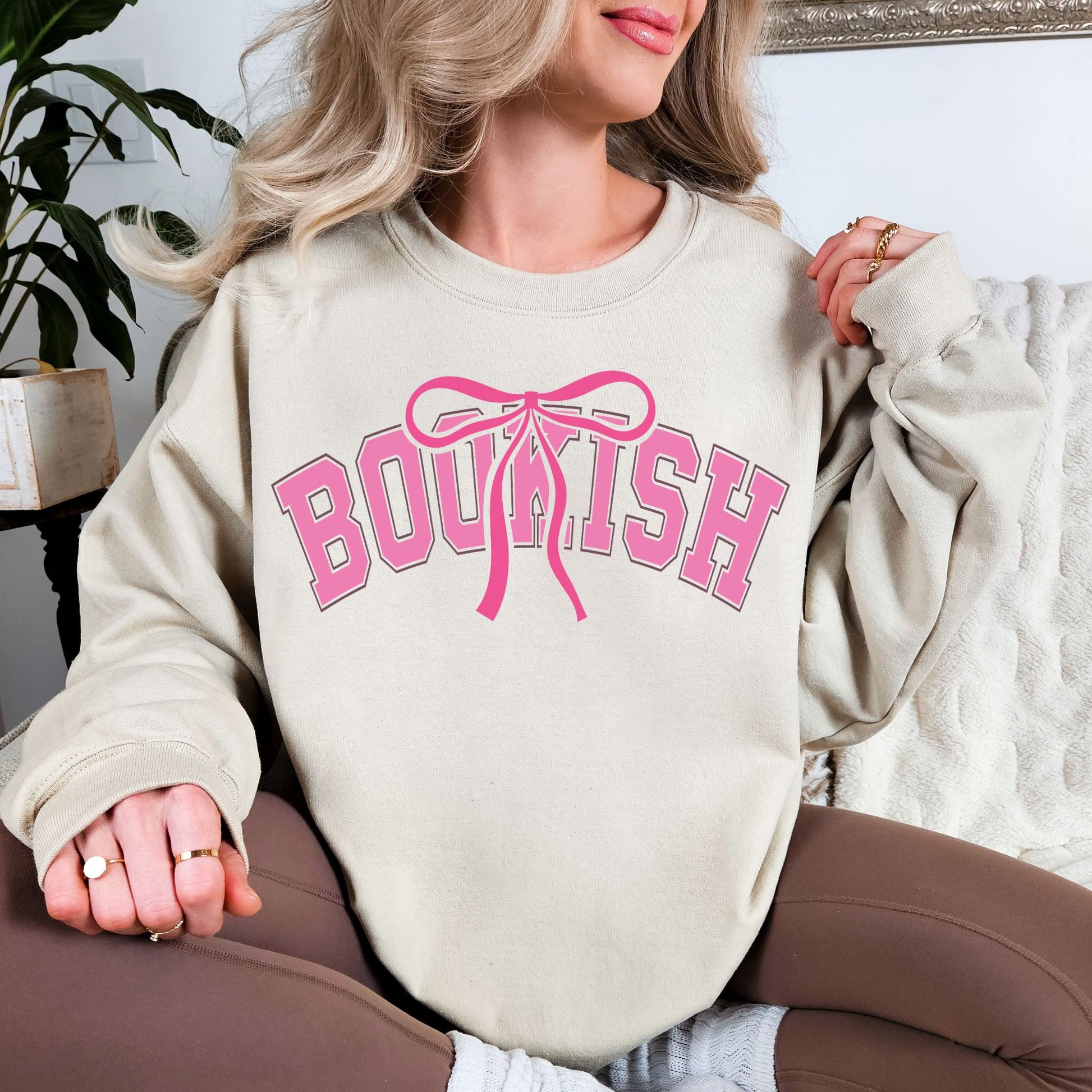 "Coquette Bookish" graphic on light warm beige (sand) Sweatshirt.