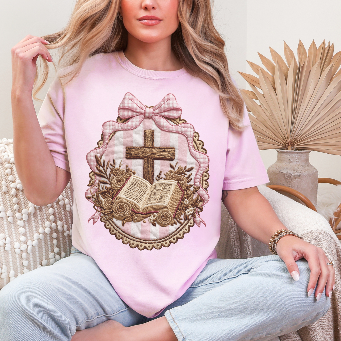 "Coquette Faux Embroidery Bible and Cross" graphic on soft pink (blossom) T-Shirt. 