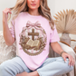 "Coquette Faux Embroidery Bible and Cross" graphic on soft pink (blossom) T-Shirt. 