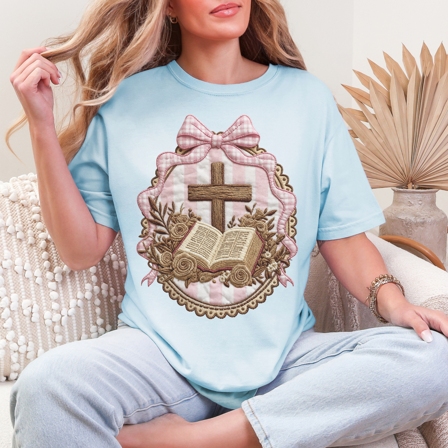 "Coquette Faux Embroidery Bible and Cross" graphic on soft medium blue (chambray) T-Shirt. 