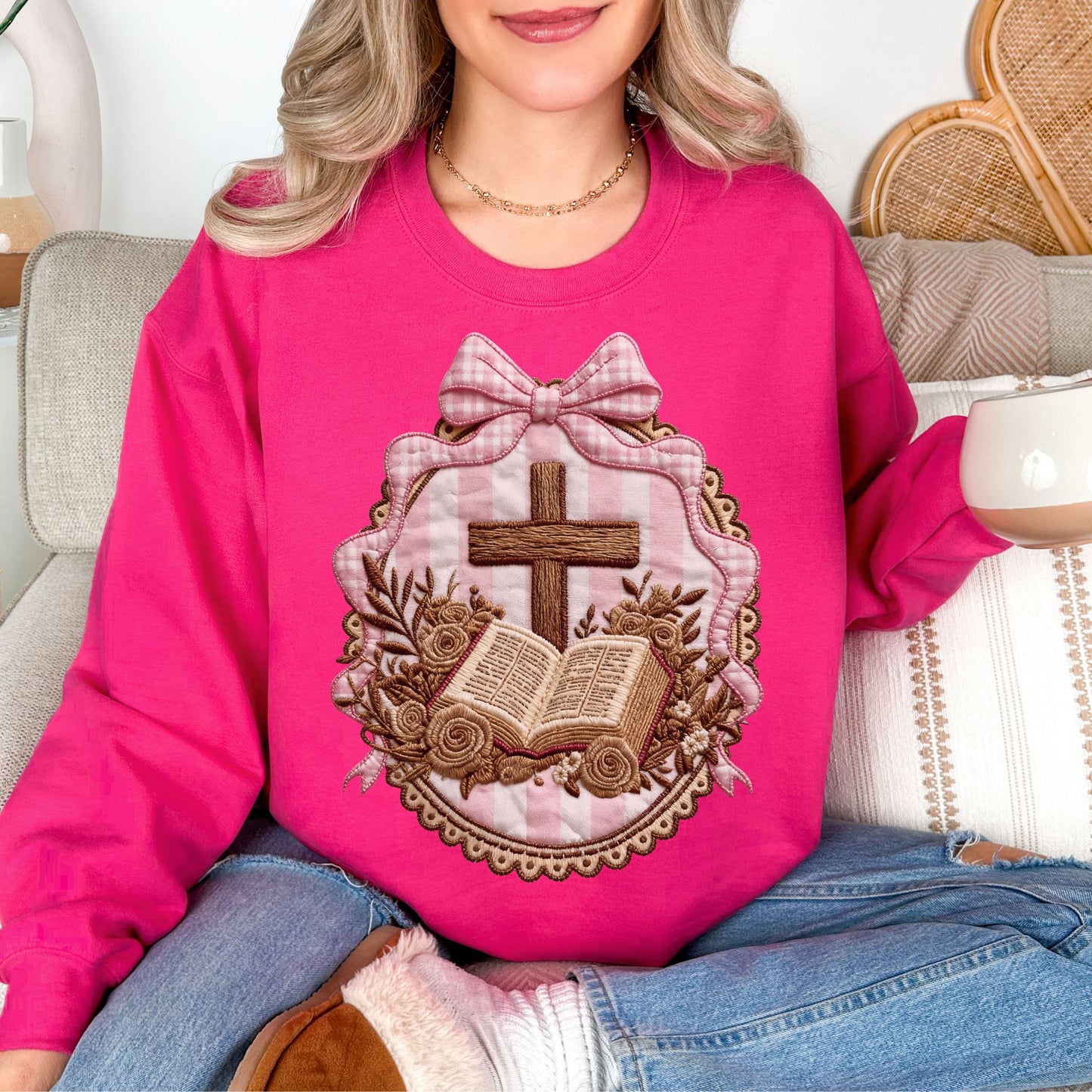 "Coquette Faux Embroidery Bible and Cross" graphic on bright pink (heliconia) Sweatshirt