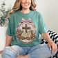 "Coquette Faux Embroidery Bible and Cross" graphic on soft light green (light green) T-Shirt. 