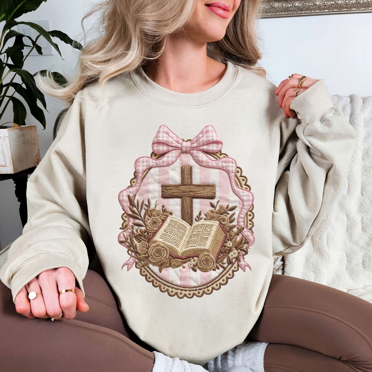 "Coquette Faux Embroidery Bible and Cross" graphic on light warm beige (sand) Sweatshirt