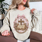 "Coquette Faux Embroidery Bible and Cross" graphic on light warm beige (sand) Sweatshirt