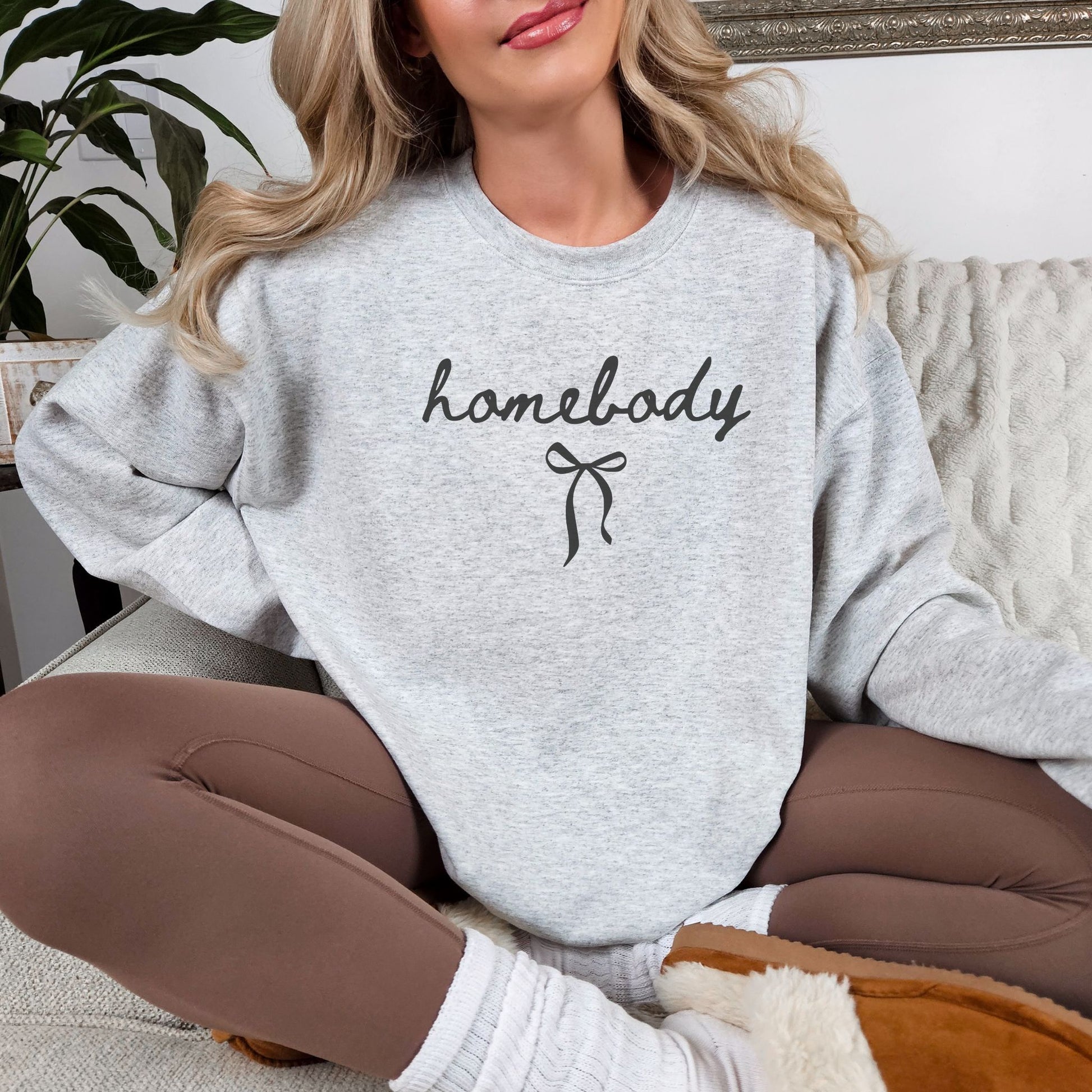 "Coquette Homebody" graphic on very light gray (ash) sweatshirt.