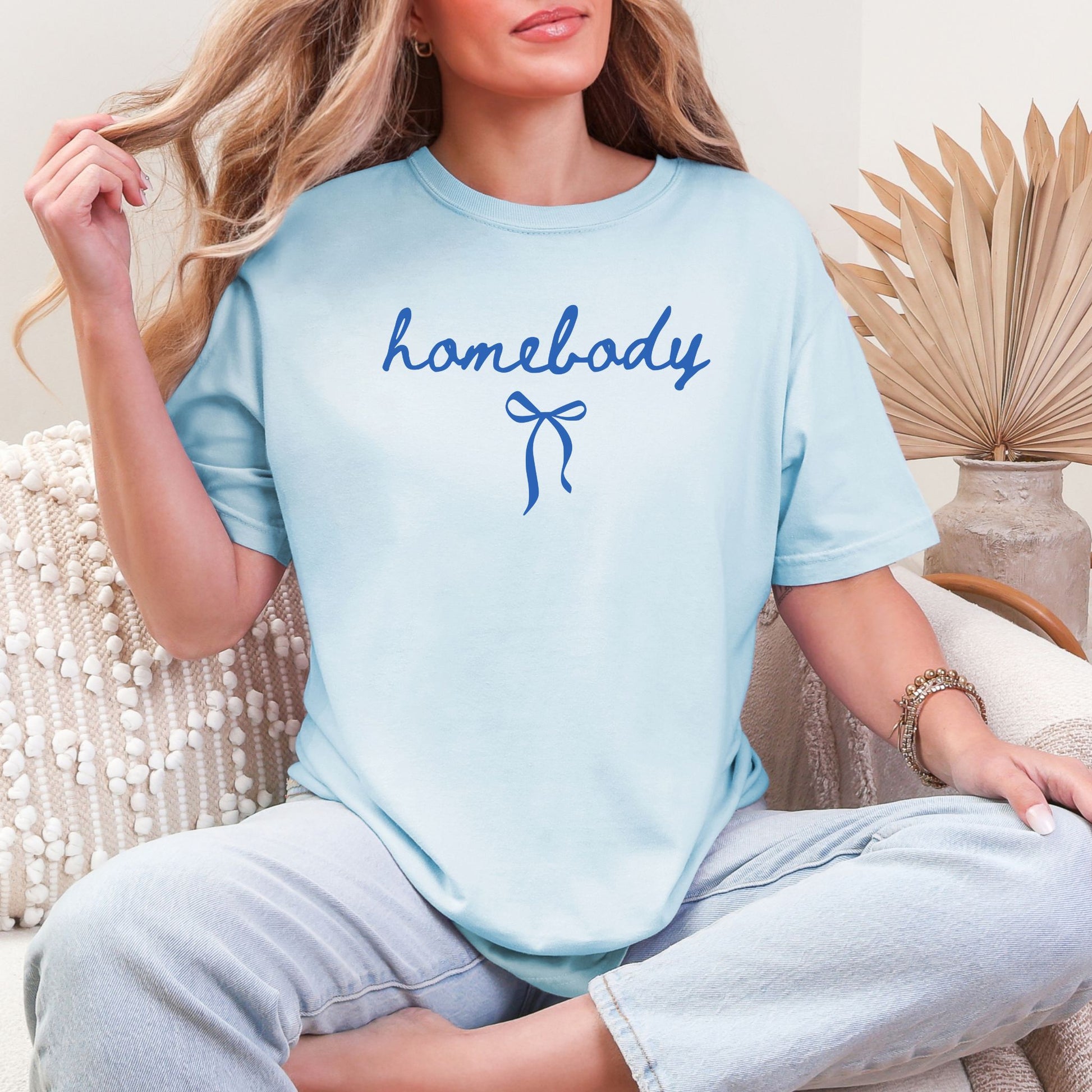 "Couquette Homebody" graphic in a soft medium blue (chambray) T-shirt.