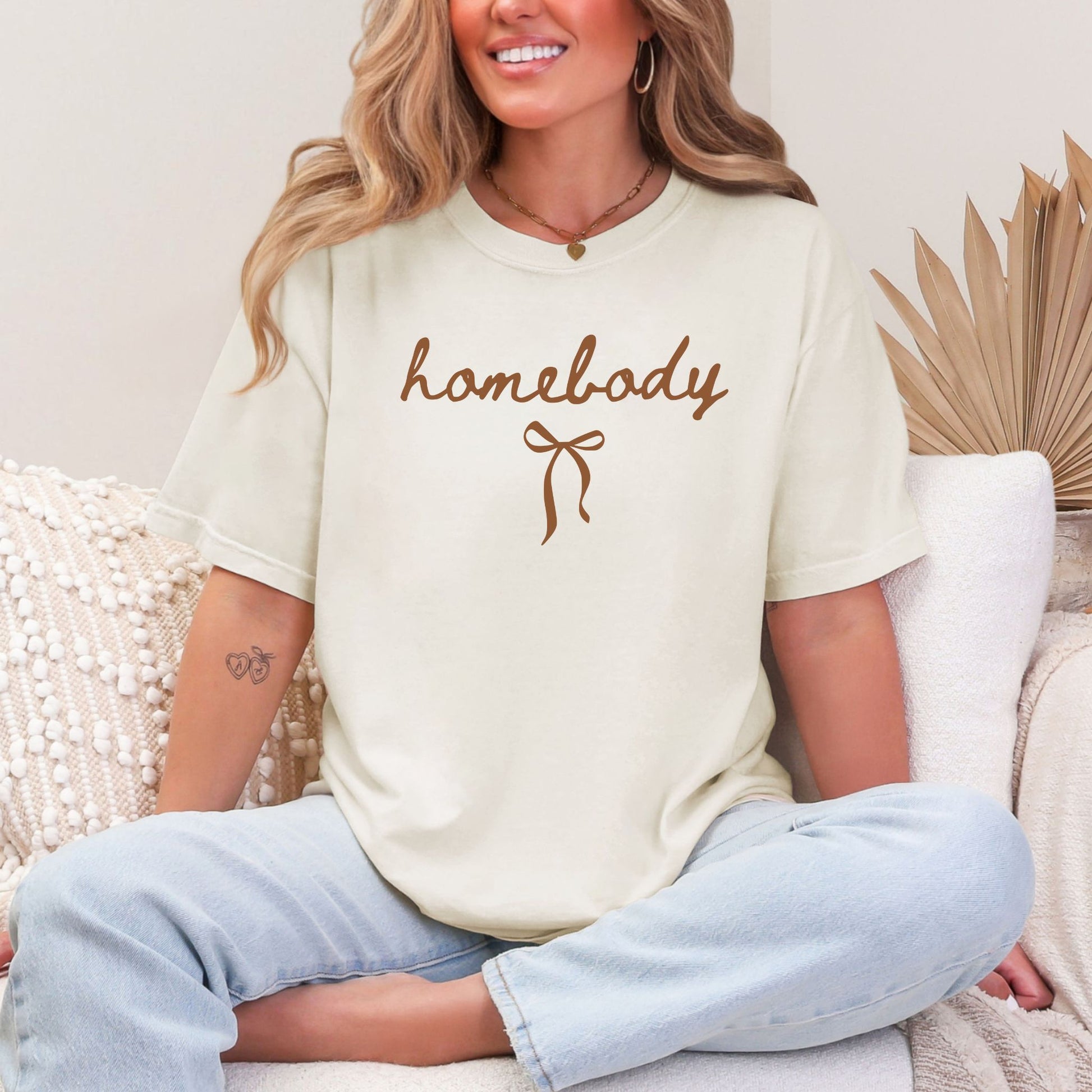 "Couquette Homebody" graphic in a soft off-white (ivory) T-shirt.