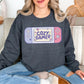 "Cozy Gamer" graphic on medium-dark heather gray (dark heather) Sweatshirt.