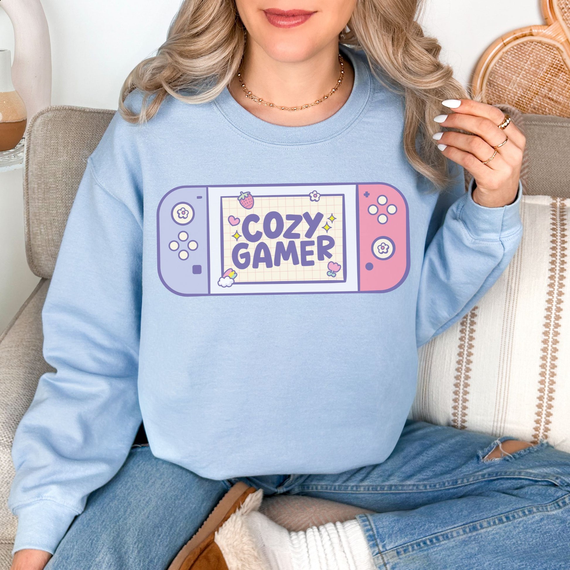 "Cozy Gamer" graphic on pale soft blue (light blue) Sweatshirt.