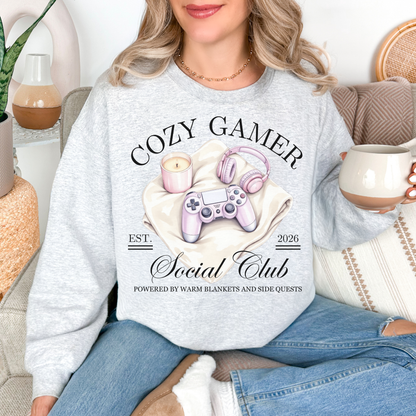 "Cozy gamer social club" graphic on very light gray (ash) Sweatshirt