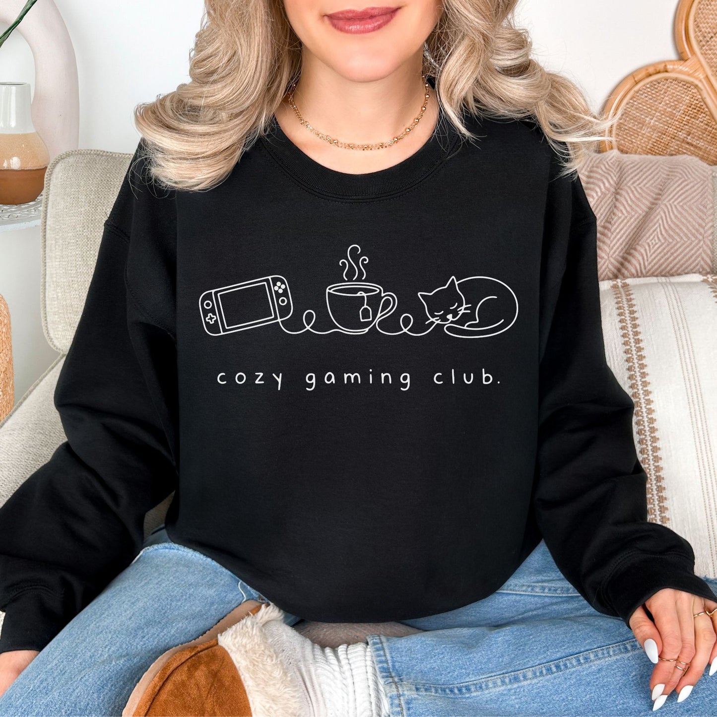 "Cozy gaming club" graphic on very black (black) sweatshirt.
