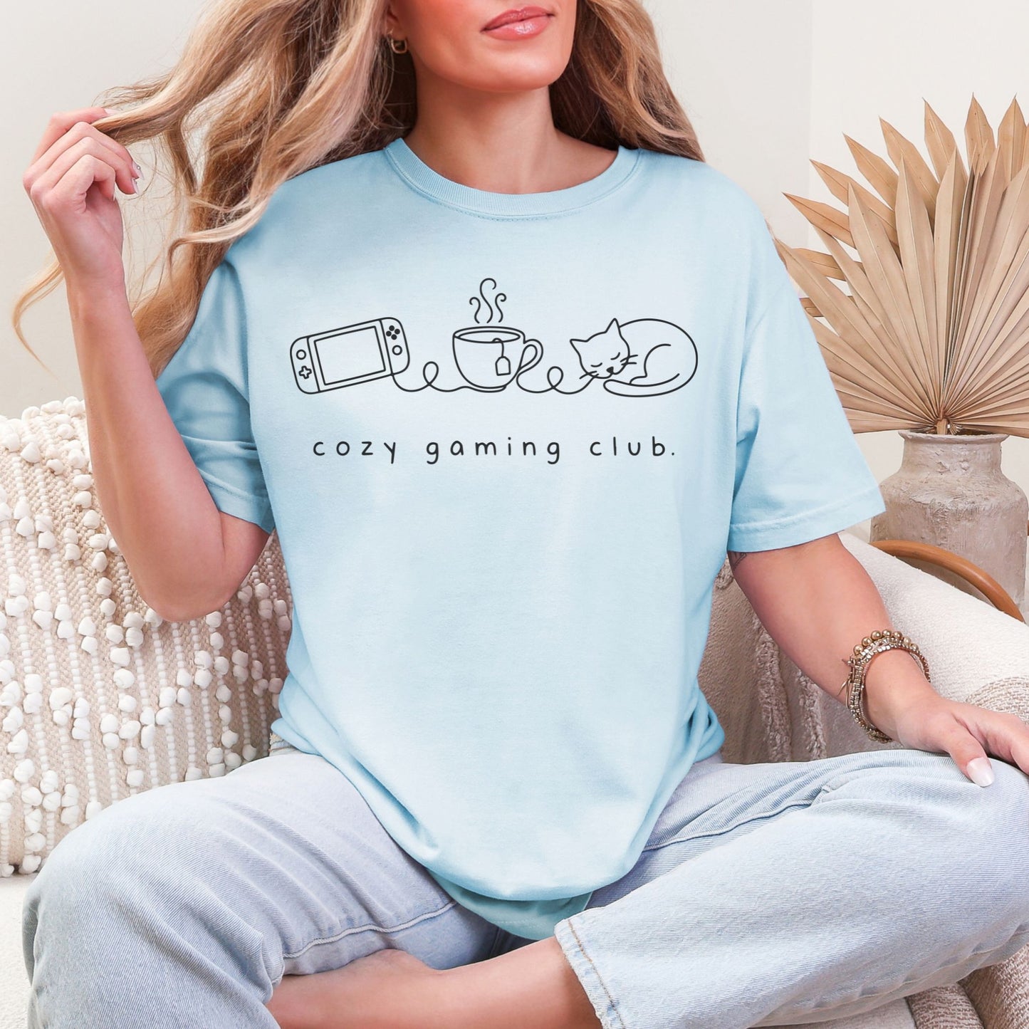 "Cozy gaming club" graphic on soft medium blue (chambray) t-shirt.