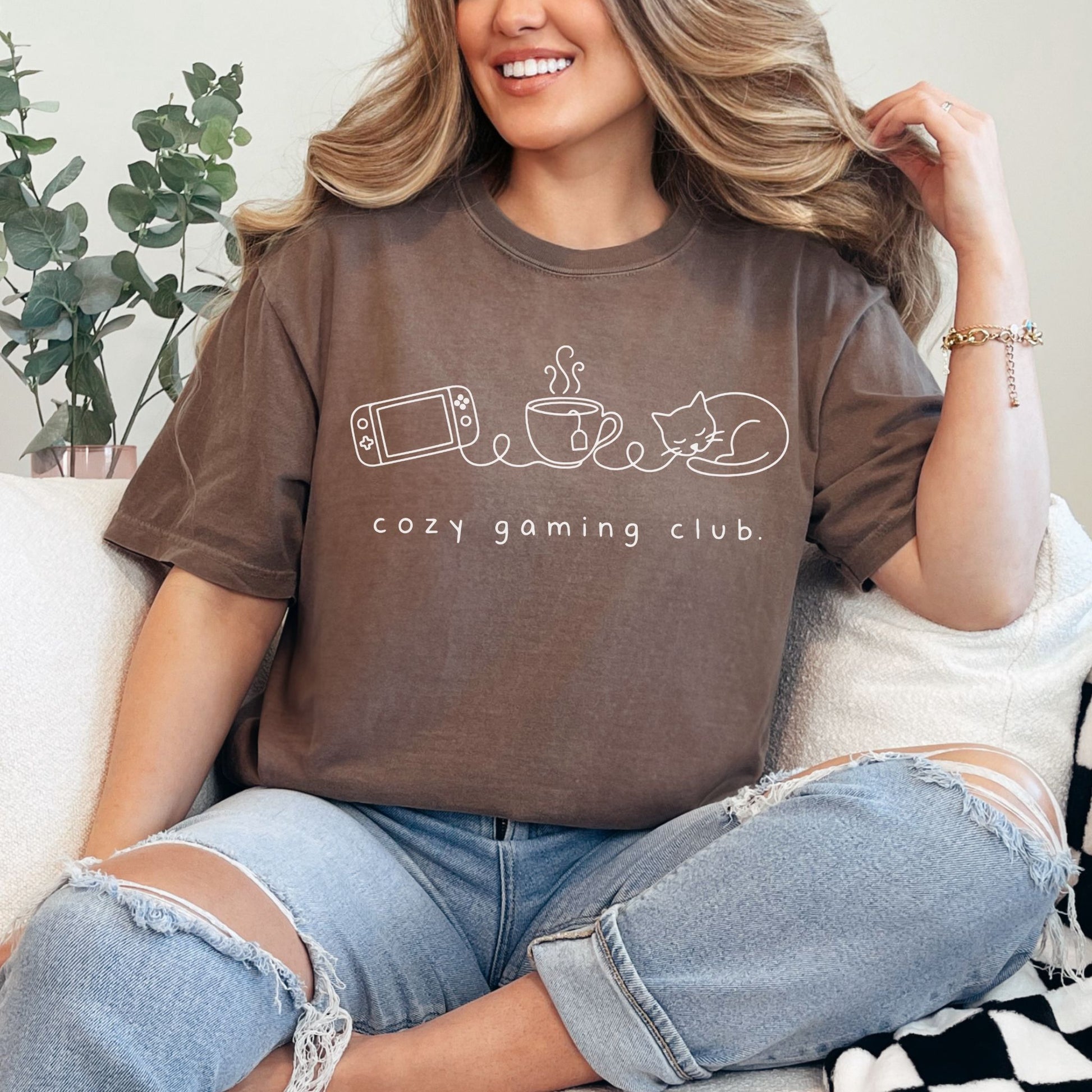 "Cozy gaming club" graphic on rich brown (espresso) t-shirt.
