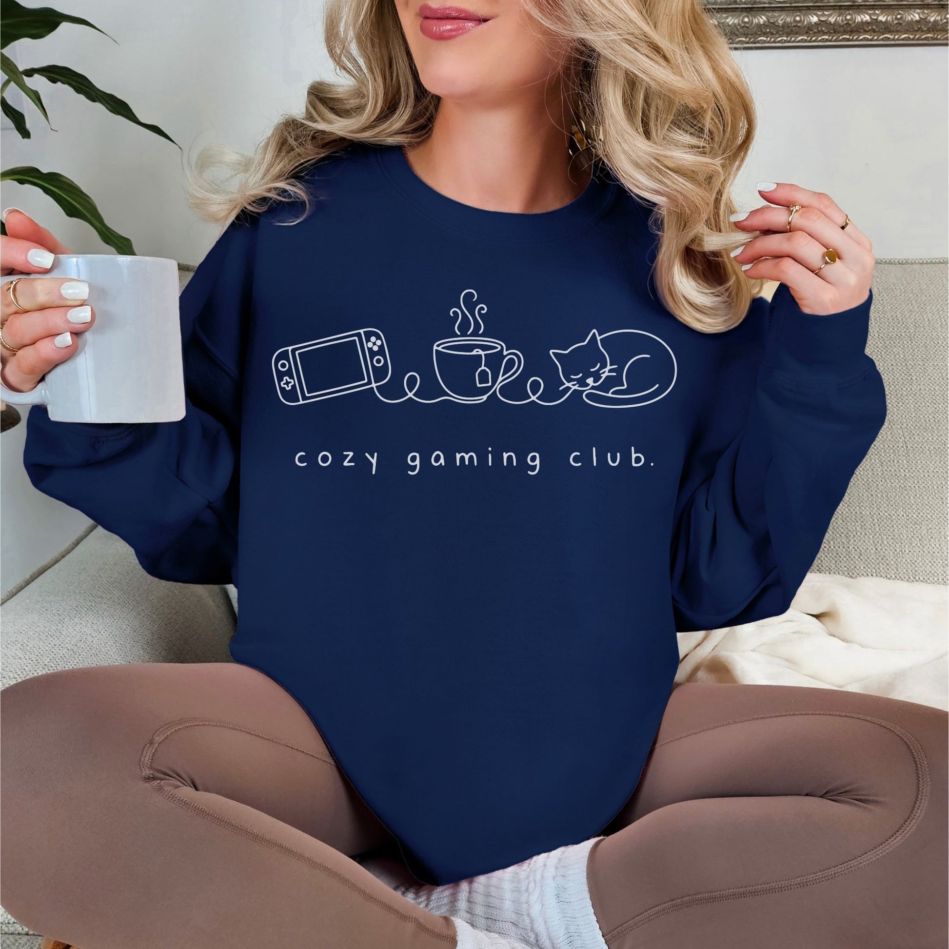 "Cozy gaming club" graphic on dark blue (navy) sweatshirt.