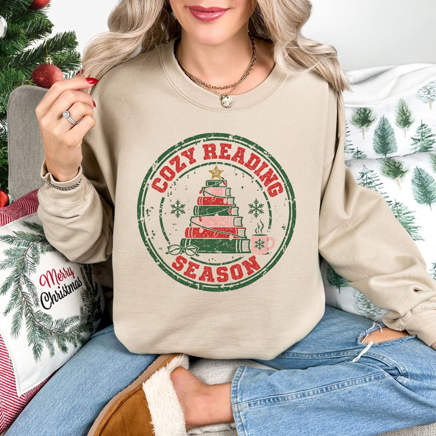 "Distressed Cozy Reading Season" graphic on a Gildan 18000 Sweatshirt in light beige (sand).