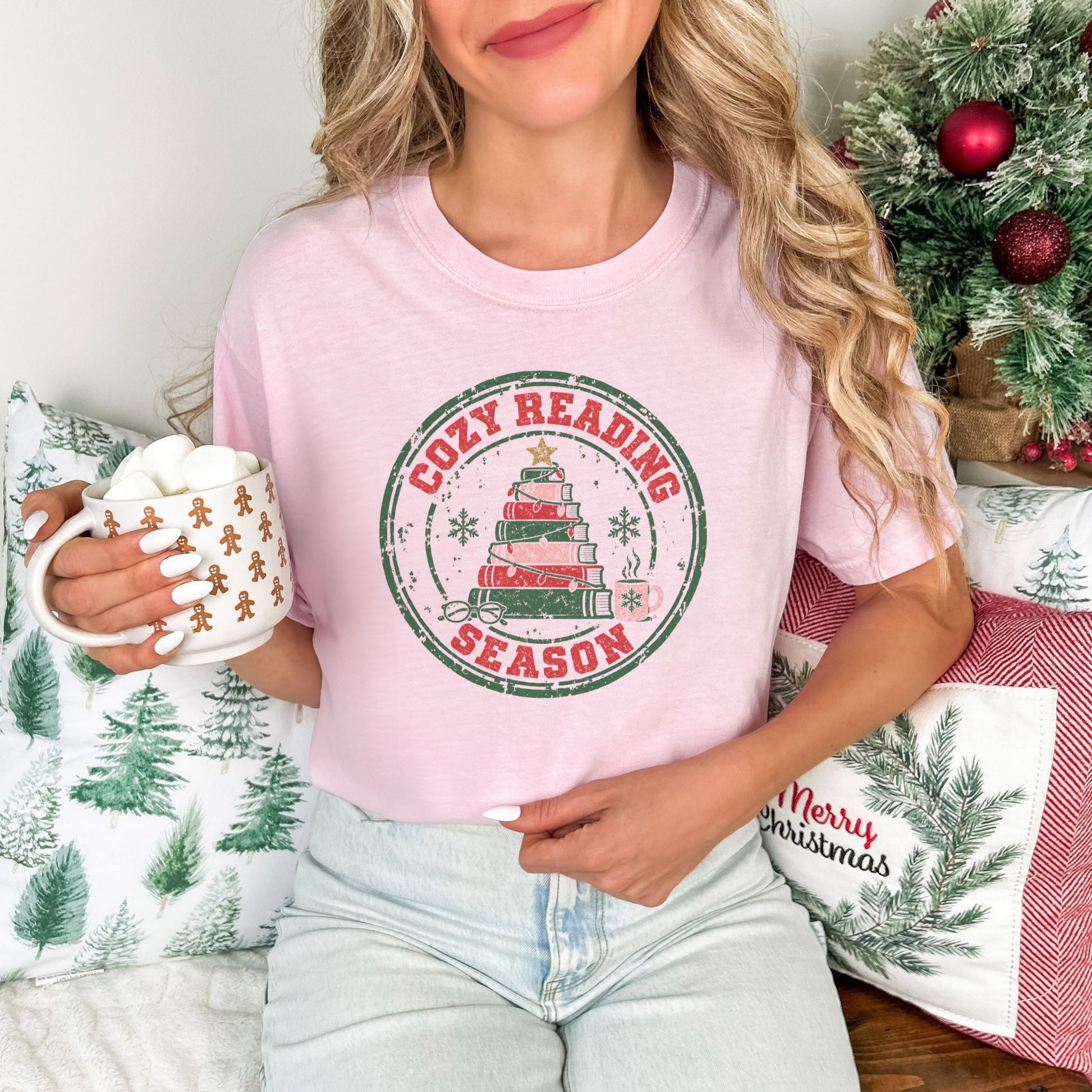 "Distressed Cozy Reading Season" graphic on a soft pink (blossom) Comfort Colors 1717 T-Shirt. 