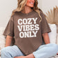 "Cozy vibes only" graphic on rich brown (espresso) T-shirt.