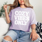 "Cozy vibes only" graphic on soft purple (orchid) T-shirt.