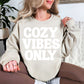 "Cozy Vibes Only" graphic on light warm beige (sand) Sweatshirt.