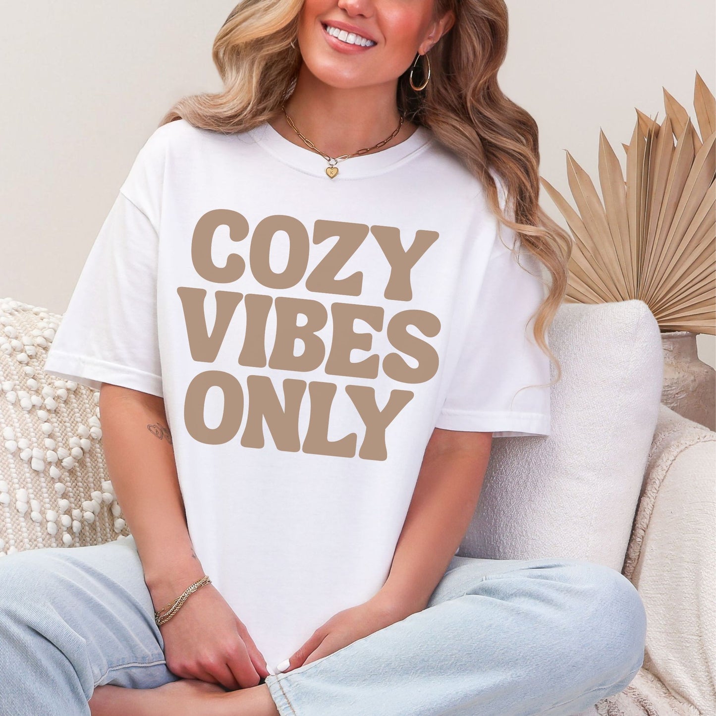 "Cozy vibes only" graphic on bright white (white) T-shirt.