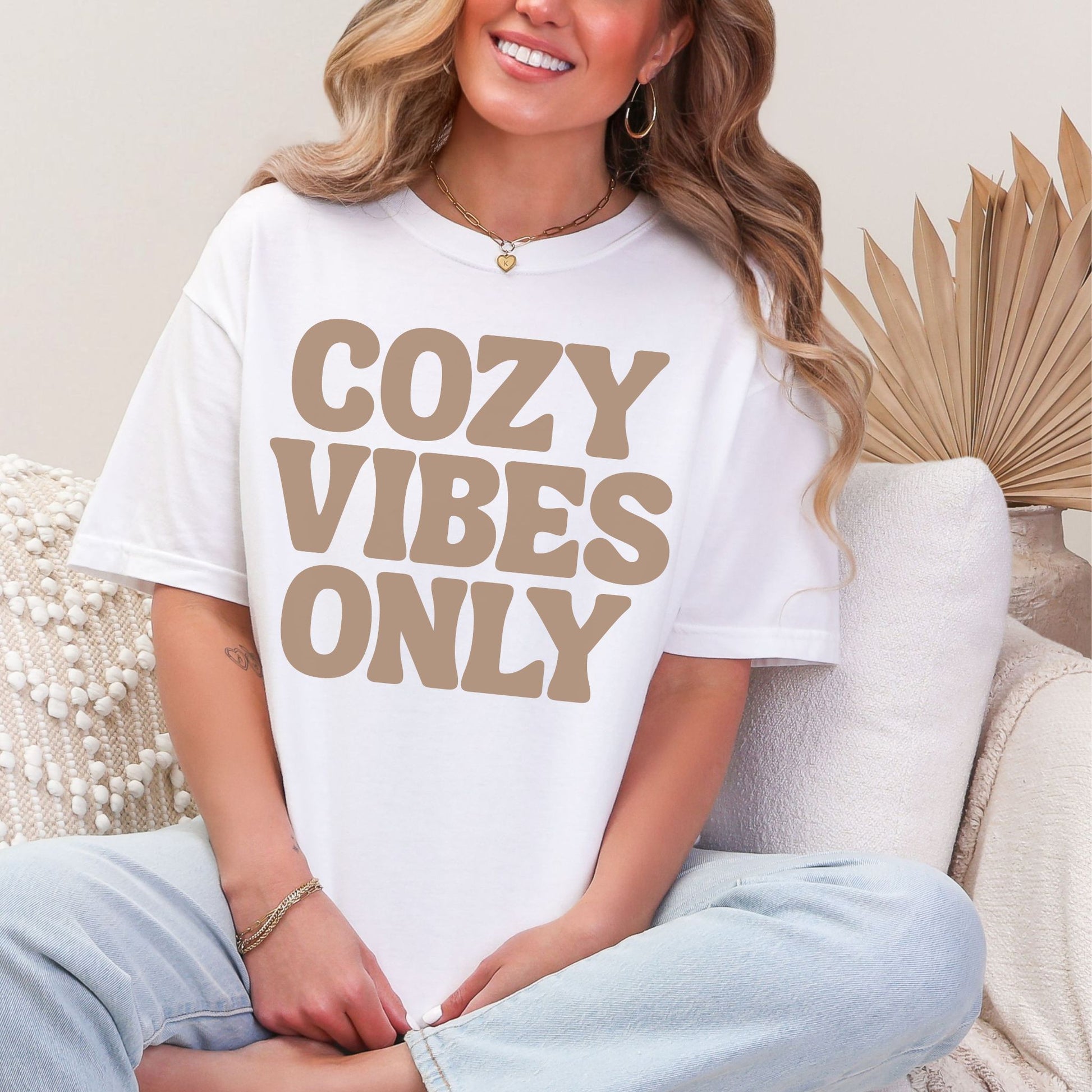 "Cozy vibes only" graphic on bright white (white) T-shirt.